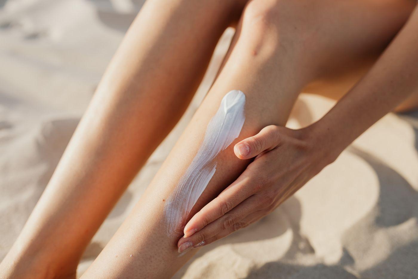 Applying insect repellent to skin outdoors