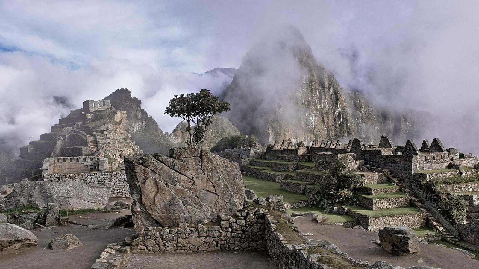 Machu Picchu citadel in the Peruvian Andes with terraced slopes and surrounding mountains